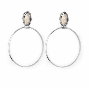 Shimmery white silver hoop earrings with an earthy white stone in the middle.